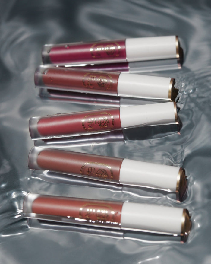 The complete collection of EM Cosmetics Lip Mage Tinted Serums, showcasing the full range of shades in a PR box.