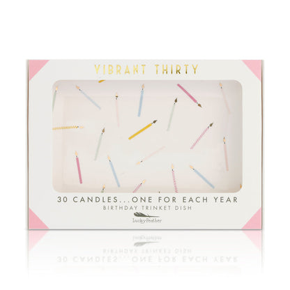 A 'Vibrant Thirty' birthday trinket dish box features a window showing a design of scattered colorful candles.