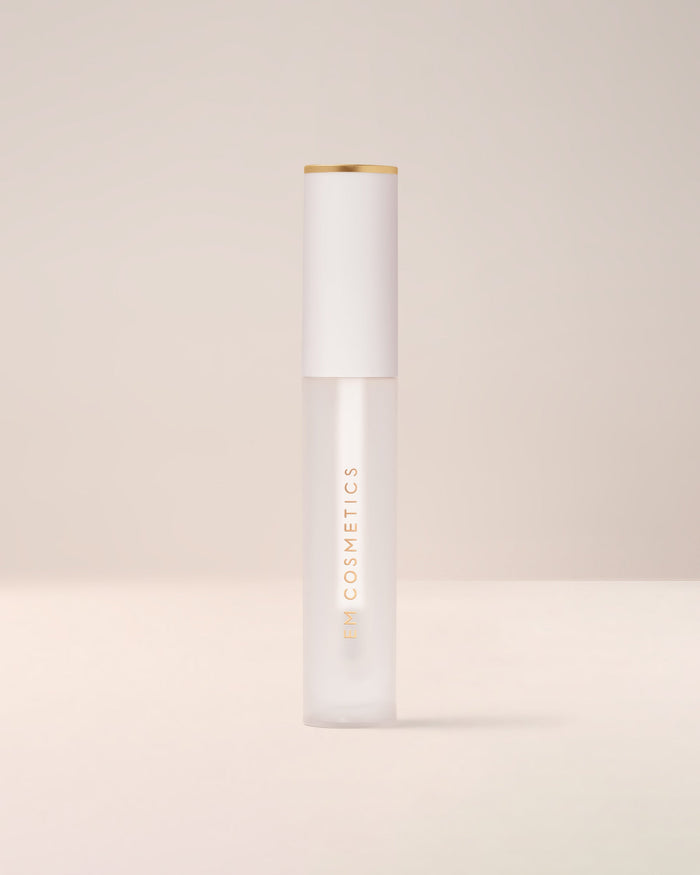 EM Cosmetics Morning Dew Crystal Lip Gloss in Quartz shown closed in its clear tube with a modern white cap.