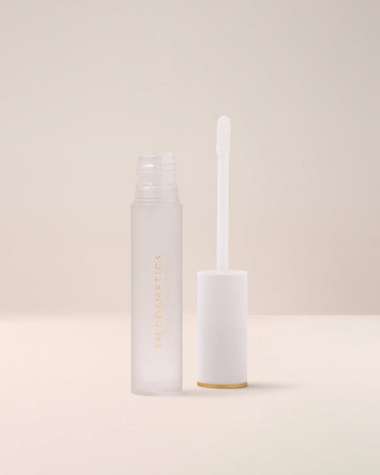 EM Cosmetics Morning Dew Crystal Lip Gloss in Quartz, a clear gloss, shown open with its applicator for a glassy finish.
