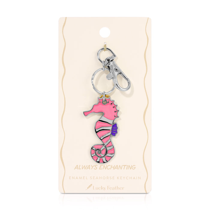 A pink seahorse keychain is displayed on its packaging.