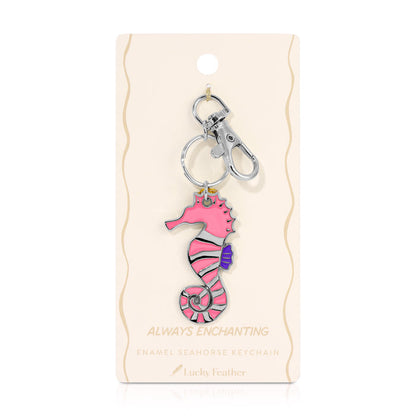 A pink seahorse keychain is displayed on its packaging.