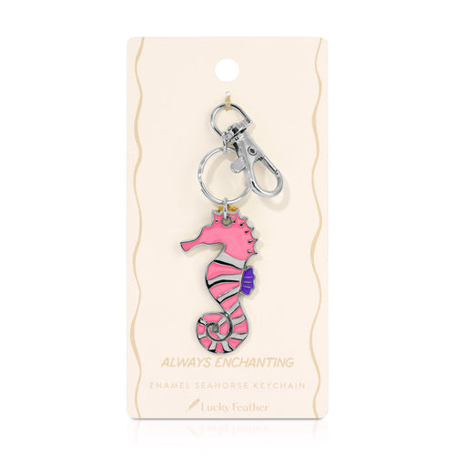 A pink seahorse keychain is displayed on its packaging.