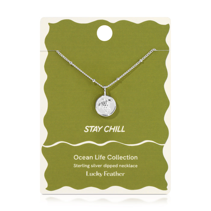 Sterling silver dipped necklace with a turtle pendant on a green and cream card that says 'Stay Chill'.