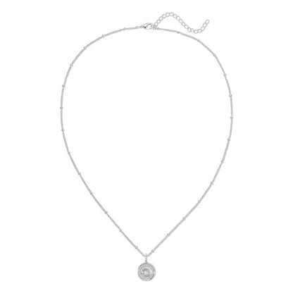 A silver chain necklace with small beads and a circular pendant with a seashell design.