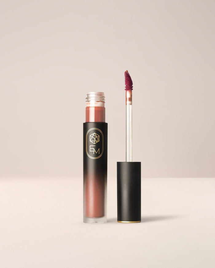 EM Cosmetics Phantom Blur Lip Tint in Sienna, a burnt orange shade that creates a warm, soft-focus matte lip.