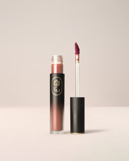 EM Cosmetics Phantom Blur Lip Tint in Sienna, a burnt orange shade that creates a warm, soft-focus matte lip.