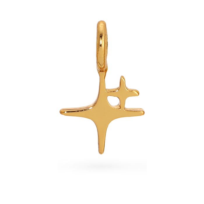 Close-up of a gold charm with a star-like design on a black background.