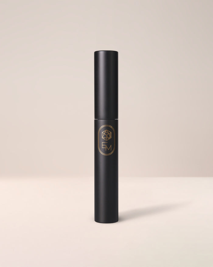 The sleek, minimalist white tube of EM Cosmetics Shapeshift Tubing Mascara, a lengthening and volumizing formula.