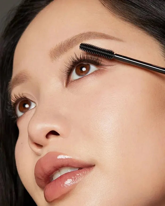 Michelle Phan holding the EM Cosmetics Shapeshift Tubing Mascara (WebP optimized)