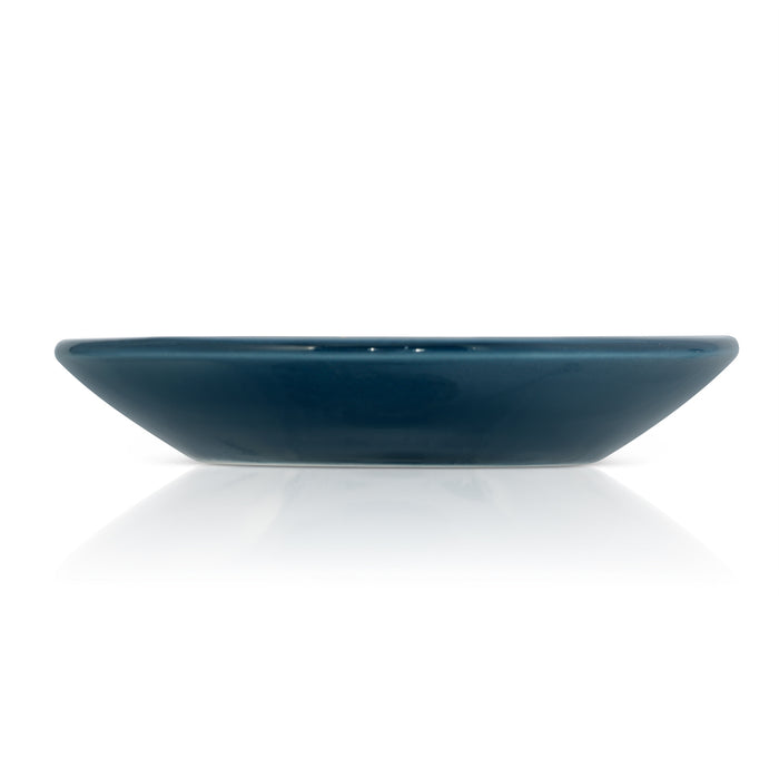 A dark blue ceramic dish with a glossy finish is shown in a side view against a white background with a reflection.