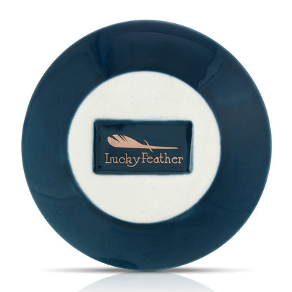 A blue and white plate with a rectangle in the middle that reads 'Lucky Feather' with a feather graphic.
