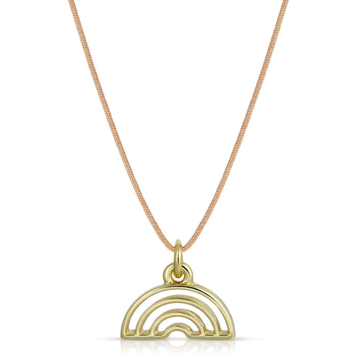 A gold-colored necklace with a rainbow pendant hangs against a white background.