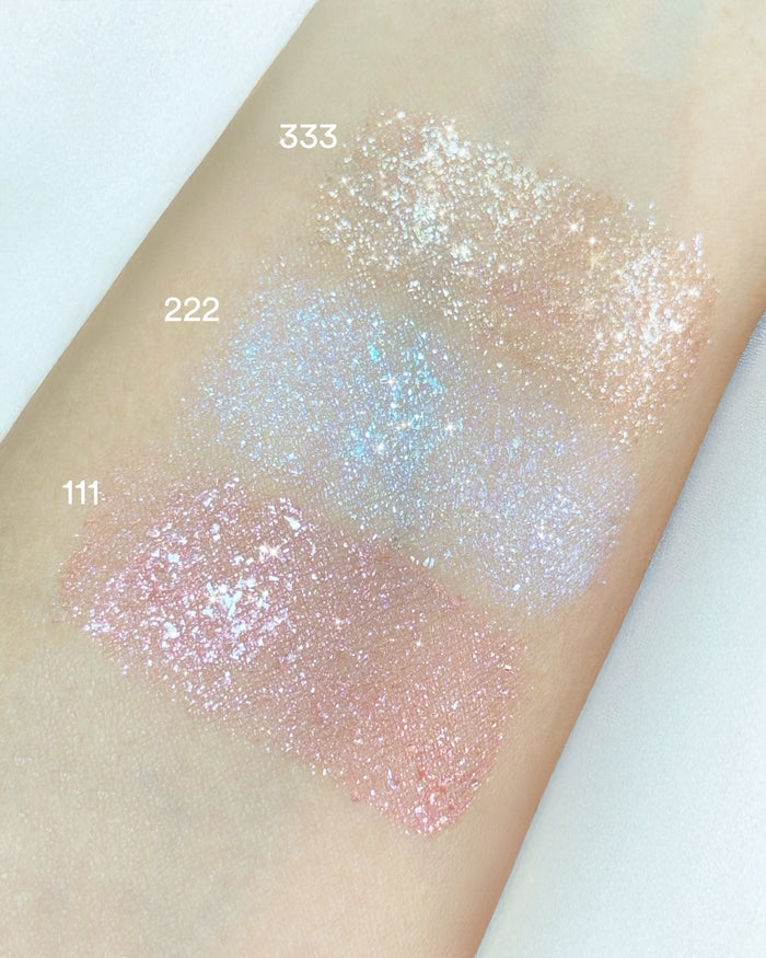 Arm swatches of EM Cosmetics Three Wishes Glitter Wands, showing sparkling and sheer finishes.